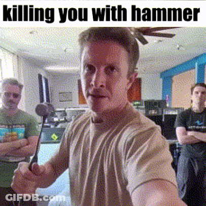 Man Holding Hammer In Living Room With Others Behind Him GIF