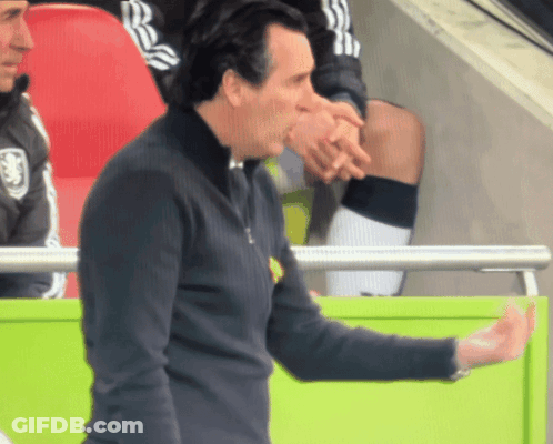 Man Holding Hand To Forehead In Front Of Arsenal Sign GIF