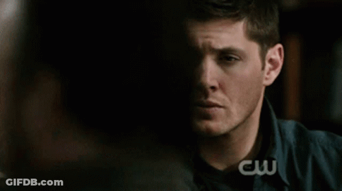 Man Holding Hand To Forehead In Front Of CW Logo GIF