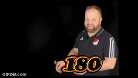 Man Holding Hand Up In Front Of Dart Board Saying Ticker Is Ticker GIF