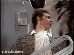 Man Holding Hanger Making Face In Mirror GIF