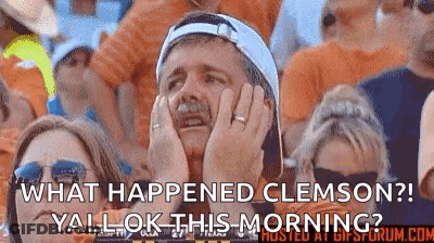 Man Holding Head In Crowd At Football Game GIF