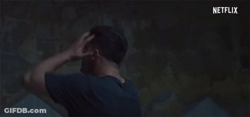 Man Holding Head In Dark Room With Netflix Logo GIF