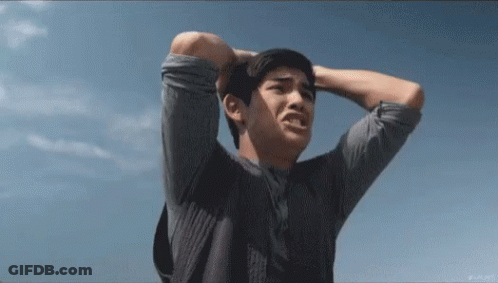 Man Holding Head In Front Of Blue Sky GIF