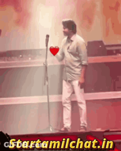 Man Holding Heart In Front Of Microphone Starttamilchat.in GIF