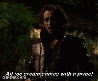 Man Holding Ice Cream Scoop And Ben & Jerry's Cup GIF