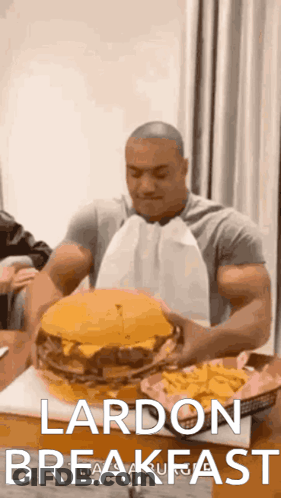 Man Holding Large Hamburger And French Fries GIF
