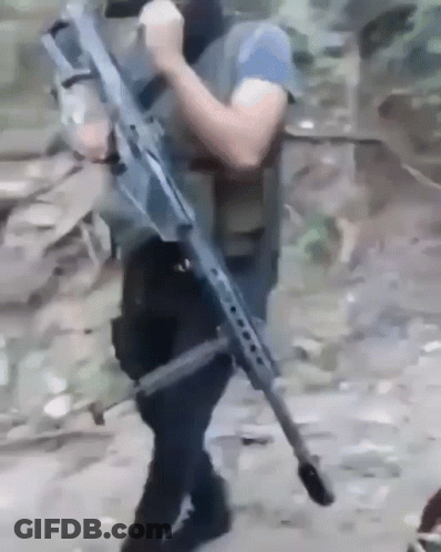 Man Holding Large Rifle GIF