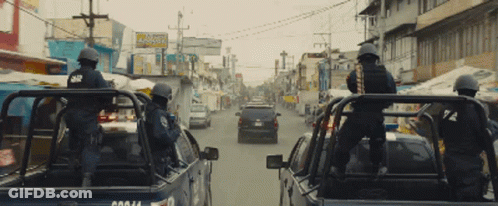 Man Holding Large Rifle In Blurry Picture GIF