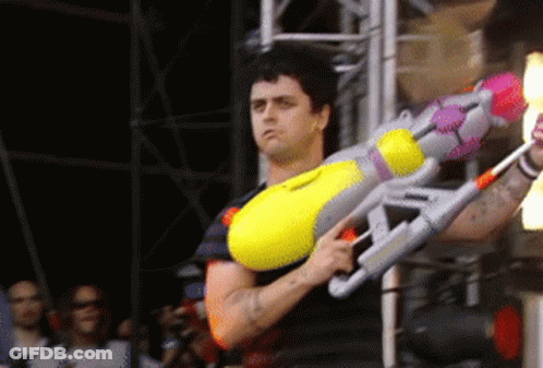 Man Holding Large Yellow Water Gun GIF