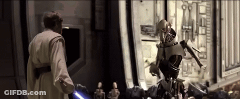 Man Holding Lightsaber Next To Robot GIF