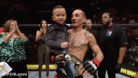 Man Holding Little Boy In Boxing Ring GIF