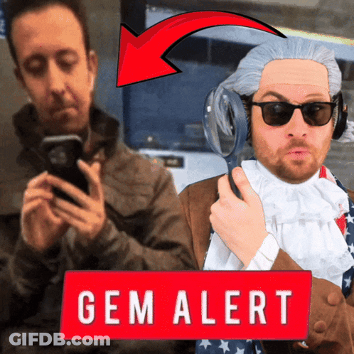 Man Holding Magnifying Glass Next To Gem Sign GIF