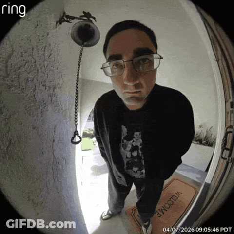 Man Holding Magnifying Glass Next To Gem Sign GIF