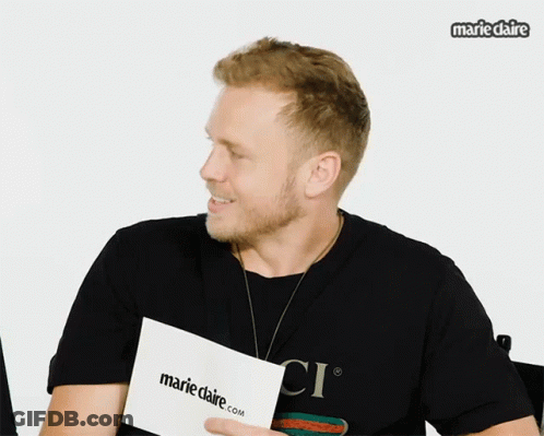 Man Holding Marieclaire.com Paper GIF