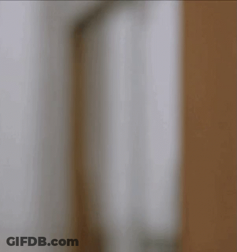 Man Holding Martini In Front Of Paramount Sign GIF