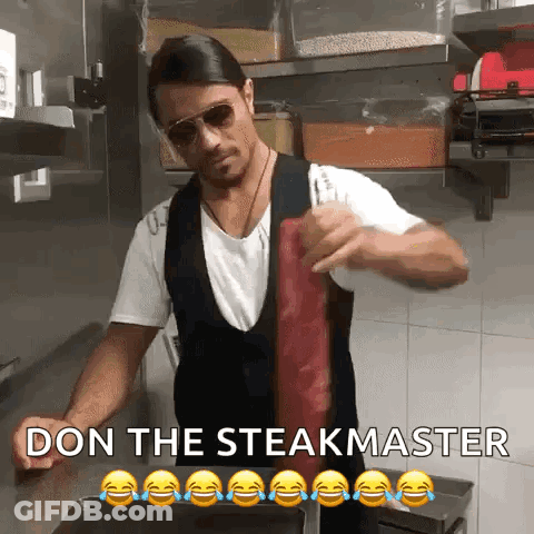 Man Holding Meat In Front Of Don The Steakmaster Sign GIF