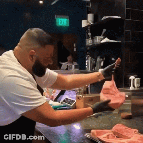 Man Holding Meat In Front Of Exit Sign GIF