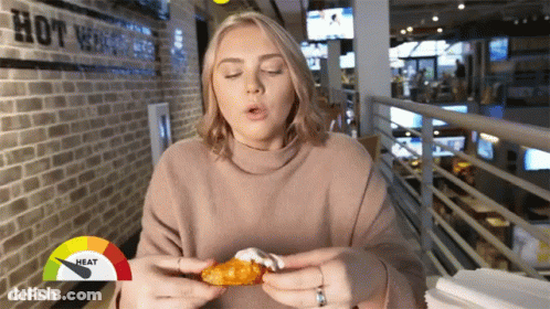 Man Holding Microphone Eating Red Pepper GIF
