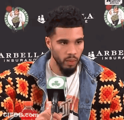 Man Holding Microphone In Front Of Arbella Insurance GIF