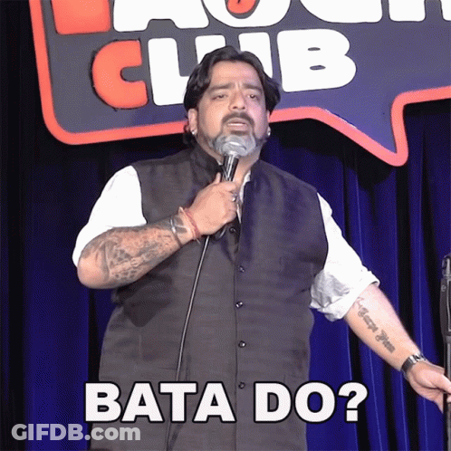 Man Holding Microphone In Front Of Bata Do Sign GIF