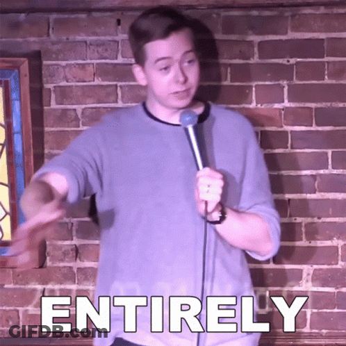 Man Holding Microphone In Front Of Brick Wall With Entirely GIF
