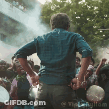 Man Holding Microphone In Front Of Crowd GIF