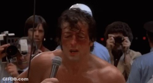 Man Holding Microphone In Front Of Crowd GIF