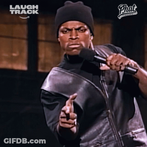 Man Holding Microphone In Front Of Laugh Track Sign GIF