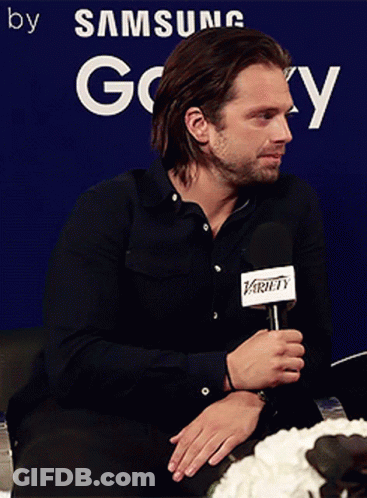 Man Holding Microphone In Front Of Samsung Sign GIF