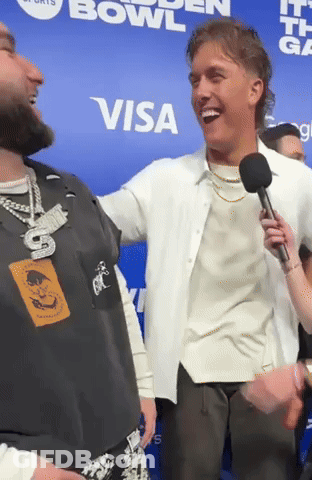 Man Holding Microphone Laughs In Front Of Visa Sign GIF
