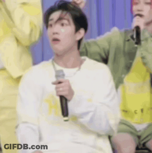 Man Holding Microphone Making Funny Face In Crowd GIF