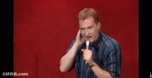 Man Holding Microphone Making Funny Face Red Background GIF