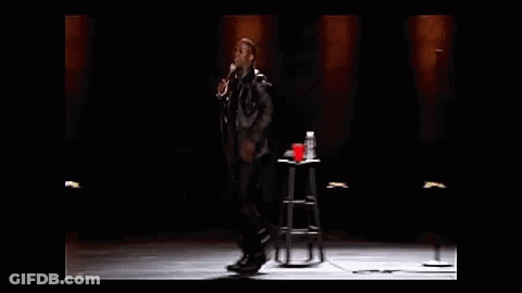 Man Holding Microphone On Stage GIF