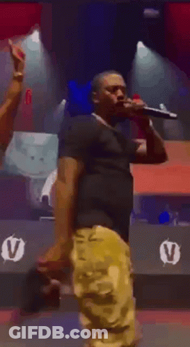 Man Holding Microphone On Stage GIF