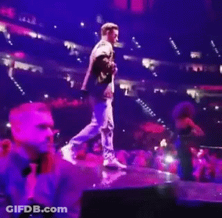 Man Holding Microphone On Stage GIF
