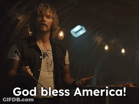 Man Holding Microphone Saying God Bless America GIF