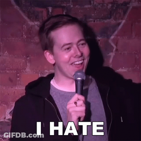 Man Holding Microphone Saying I Hate In Front Of Brick Wall GIF
