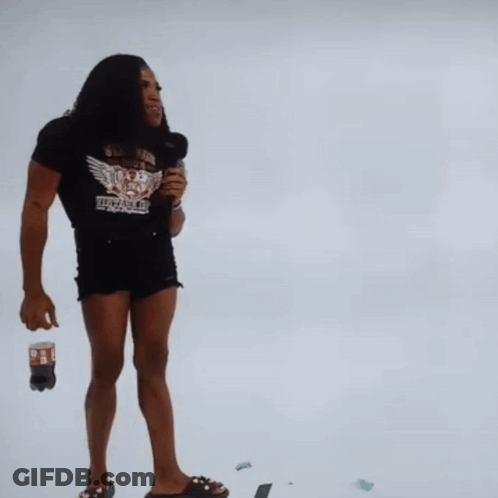 Man Holding Microphone To Woman's Shoulder GIF
