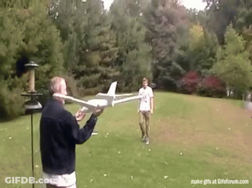 Man Holding Model Airplane And Another Looking On GIF