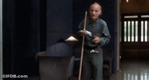 Man Holding Mop In Hallway GIF