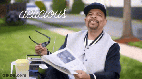 Man Holding Newspaper Saying Delicious GIF