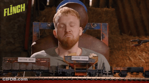 Man Holding Paintball Gun In Front Of Flinch Sign GIF