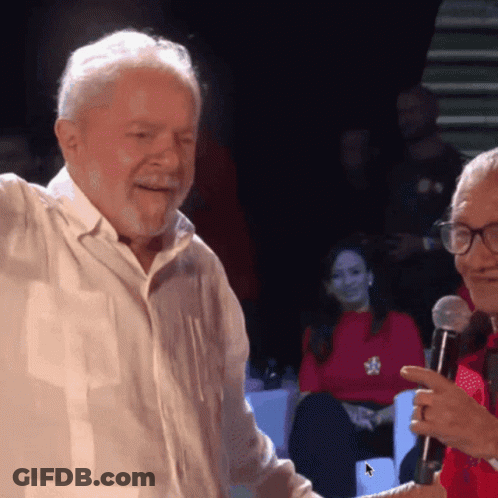 Man Holding Paper Giving Speech At Microphone GIF