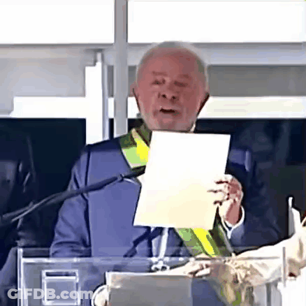 Man Holding Paper Giving Speech At Microphone GIF