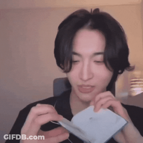 Man Holding Paper Making Face GIF