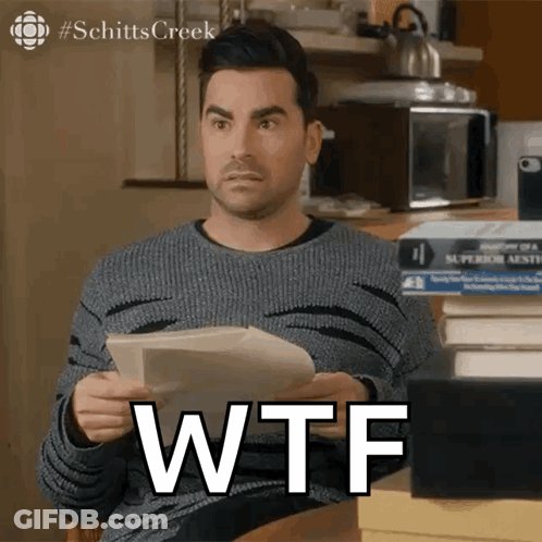 Man Holding Paper That Says WTF GIF