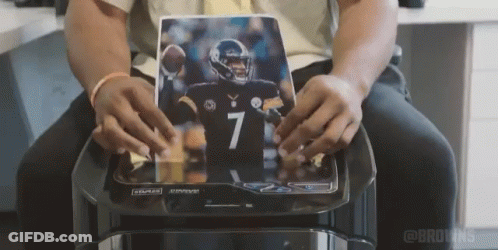 Man Holding Picture Of Football Player Number 7 Jersey GIF