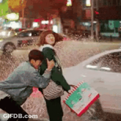 Man Holding Pizza Box Pushing Woman In Rain GIF