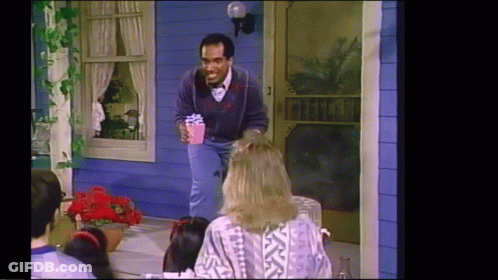 Man Holding Present At Blue House GIF